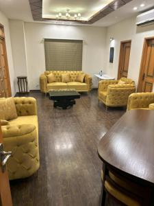 a waiting room with couches and a table at 3-Bedrooms Luxury Apartment in Lahore