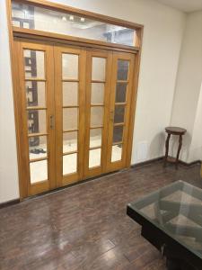 a room with a large wooden door and a table at 3-Bedrooms Luxury Apartment in Lahore