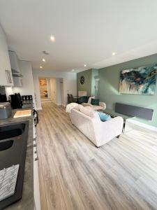 a living room with two couches and a kitchen at Mary McGill’s in Ballycastle