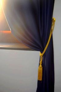 a blue curtain with a yellow rope attached at B&B Al Mare Sorrento in Sorrento