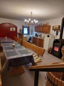 a kitchen with a table and a dining room at Kis sori Vendégház Császártöltés in Császártöltés