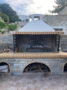 a brick oven with snow on top of it at Manousos Guest House in Heraklio