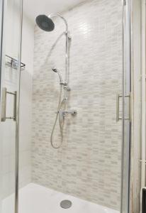 a shower with a glass door in a bathroom at Havre de paix in Courcouronnes