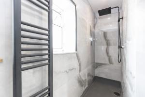 a shower with a glass door in a bathroom at H C Property - Doublegait in Barnard Castle