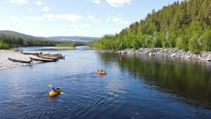 a group of people in kayaks on a river at Sorrisniva Arctic Wilderness Lodge in Alta