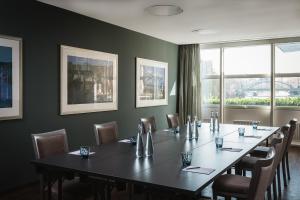 a conference room with a long table and chairs at ABION Villa Suites in Berlin