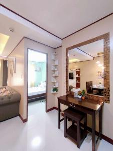 a living room with a table and a mirror at Palawan Paradise Condotel 2B in Puerto Princesa City