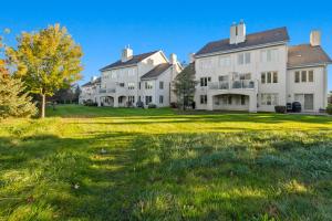 a row of white houses on a green lawn at Steps to Blue Mtn Condo wt Elegant Style 213 Sierra Lane in Blue Mountains