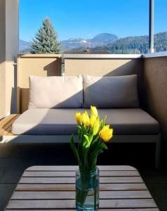a vase of yellow flowers sitting on a table at Alpenpanorama Oase in Feldkirch