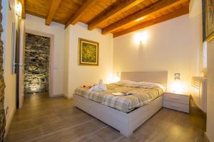 a bedroom with a bed and a wooden floor at Medioevo In Centro in Como