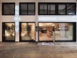 a building with sliding glass doors with a dining area at The Newel Acropolis in Athens