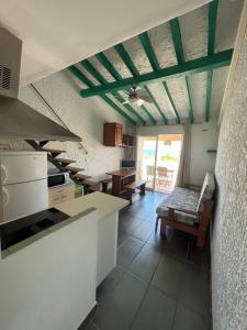 a kitchen with a couch and a table in it at RESIDENCE LA PLAGE Pieds dans l'eau Belle Vue mer in Linguizzetta