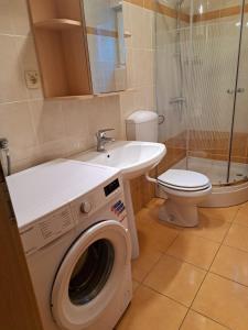 a bathroom with a washing machine and a sink at Apartments Coral, Klimno, island Krk in Klimno