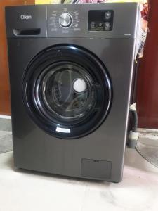 a black washing machine sitting on a floor at Sahara Hostel and Private rooms in Dubai