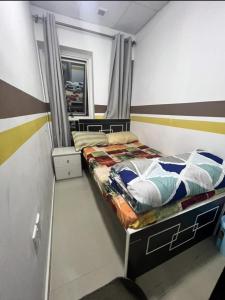 a small bedroom with a bed and a mirror at Sahara Hostel and Private rooms in Dubai