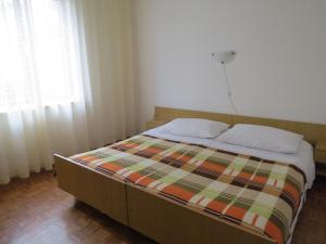 Postel nebo postele na pokoji v ubytování Apartments INES
