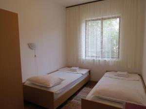 Postel nebo postele na pokoji v ubytování Apartments INES