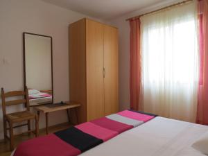 Postel nebo postele na pokoji v ubytování Apartments INES