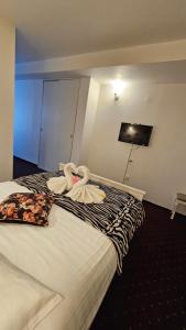 Voodi või voodid majutusasutuse Hotel Olimp toas