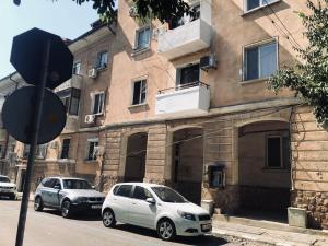 two cars parked in front of a building at Bluemoon-Apartment with Parking in Burgas