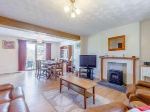 a living room with a couch and a fireplace at 3 Bed in Gower 72846 in Port-Eynon