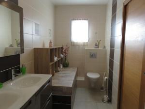 a bathroom with a sink and a toilet at Les Clos De La Vigne in Vals-les-Bains