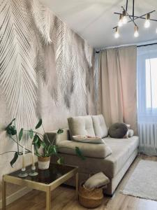 a living room with a couch and a table at Apartament lovely space in Rzeszów