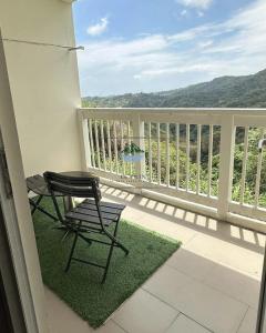 a balcony with a chair and a table on a porch at Twin Lakes Tagaytay - Le Prin in Tagaytay