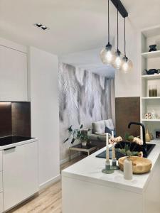 a kitchen and living room with a white counter top at Apartament lovely space in Rzeszów