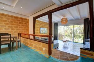 a living room with a brick wall at Beachfront villa in Oualidia in Oualidia