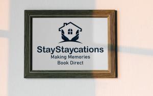 a picture of a sign in a frame on a wall at Treorchy Terrace by StayStaycations in Treorky