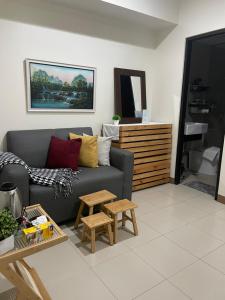 a living room with a couch and a table at 1 Bedroom Condo near ICC Megaworld with netflix in Iloilo City