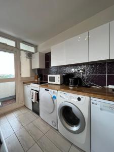 a kitchen with a washer and dryer in it at Amazing view 2 bedroom in Abbey Road in London