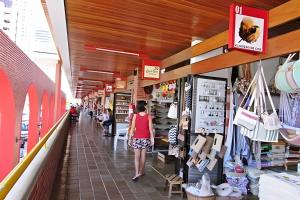 a woman walking down the aisle of a store at ESPETACULAR 1 dorm com piscina em Manaíra! in Tambaú