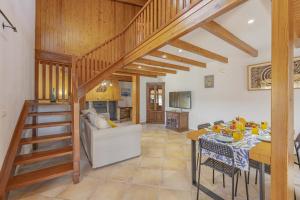 a living room with a staircase leading to a living room at Villa Son Rotger in Alcudia