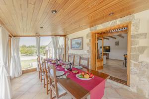 a dining room with a table with a purple table cloth at Villa Son Rotger in Alcudia