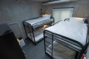 a room with two bunk beds and a window at Big K House in Busan