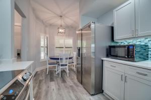 a kitchen with a table and a microwave at Luxury 2 bed and 2bath Lakefront Condo Near IMG and Anna Maria Island in Bradenton +31 photos