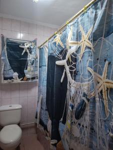 a bathroom with a toilet and a shower curtain at شقه للايجار مكرم عبيد 1 in Cairo