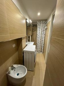 a small bathroom with a sink and a toilet at Monolocale "Raja" in Agropoli