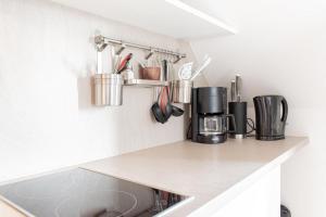 a kitchen counter with cups and utensils on it at Ferienwohnung Strandnah in Timmendorfer Strand