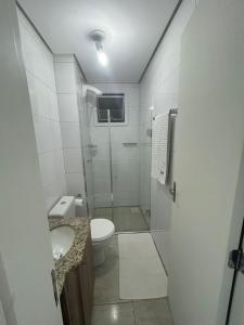 a bathroom with a shower and a toilet and a sink at Loft Central in Passo Fundo