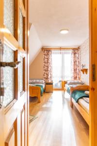 a room with two beds and a window at Pokoje Gościnne Aniela Stasik in Gliczarów Górny