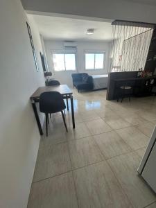 a living room with a table and a couch at Loft Central in Passo Fundo