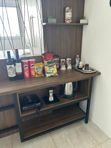 a shelf with food and other items on it at Loft Central in Passo Fundo