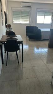 a living room with a couch and a table at Loft Central in Passo Fundo