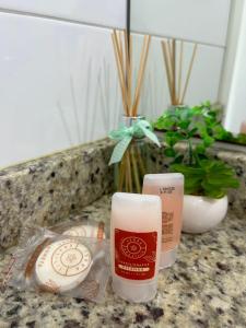 a candle on a counter next to a bag of food at Loft Central in Passo Fundo