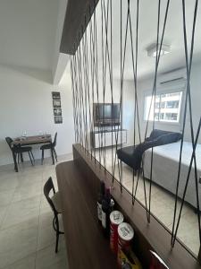 a bedroom with a bed and a dining room with a table at Loft Central in Passo Fundo