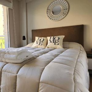 a bedroom with a large white bed with pillows at STUDIO MODERNO EN PUERTO MADERO FRENTE AL HOTEL MADERO in Buenos Aires