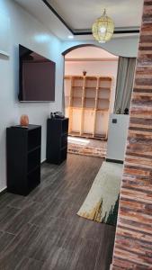 a room with a flat screen tv and a wall at Taghazout Panoramic in Taghazout
